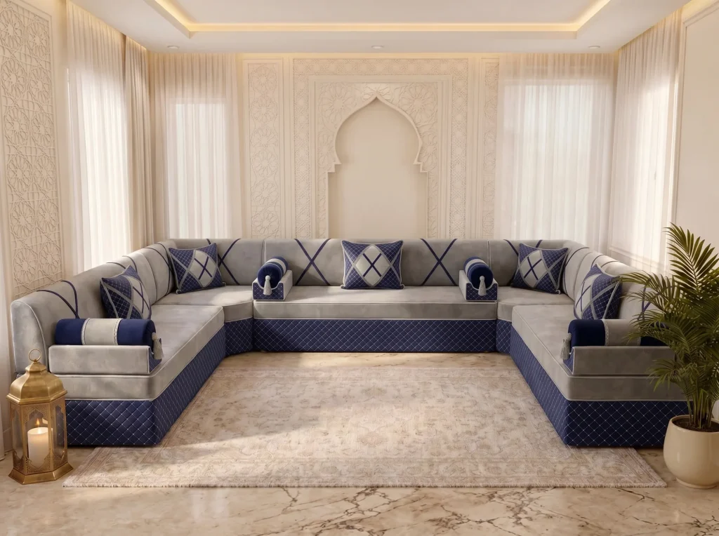 Light grey and navy U-shaped Arabic majlis with a quilted base and navy cushions around a cream rug