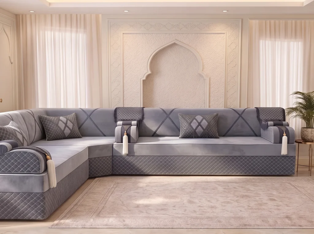 Low front view of a long grey velvet jalsa with a quilted base turning the corner at the left