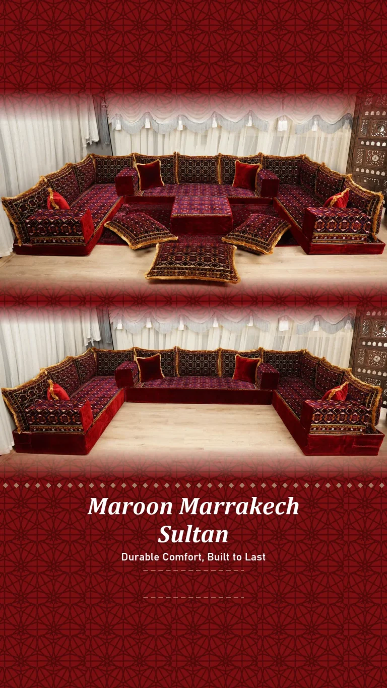Deep maroon floor seating set with gold-fringed backs arranged in a U shape before white pelmet curtains