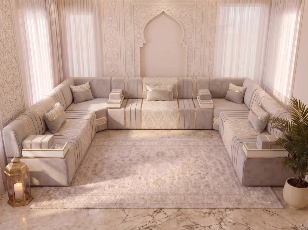 Elevated front view of a beige velvet majlis sofa set in a U shape with damask panels around a cream rug on marble
