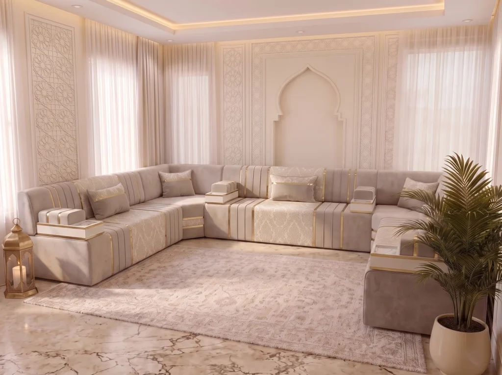 Side-angle view of a beige velvet majlis sofa in a U shape with damask panels, tray armrests and a palm in the foreground
