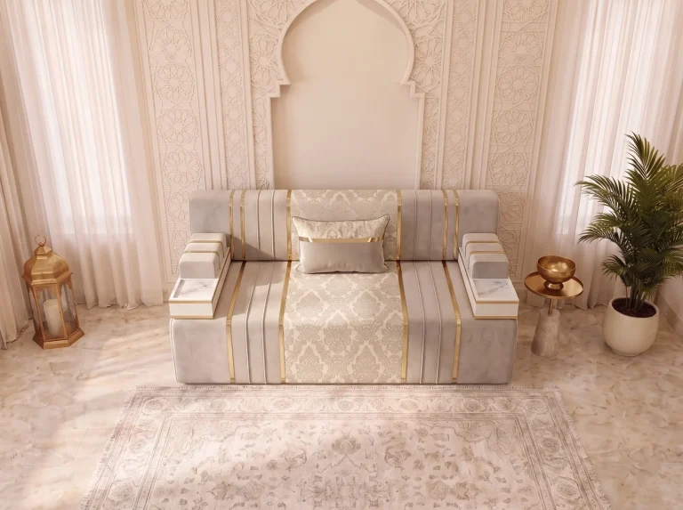 High-angle view of a single beige velvet majlis sofa module with a damask seat panel and two marble-top tray armrests