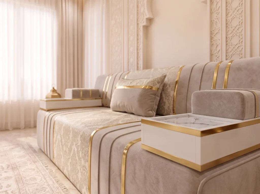 Close-up of a white marble-top armrest tray with gold edging on a beige velvet majlis sofa with a damask seat panel