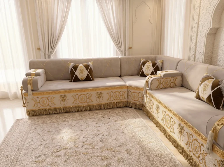 Beige Arabic majlis in an L shape with gold-embroidered cream bases and brown diamond pillows in front of sheer curtains