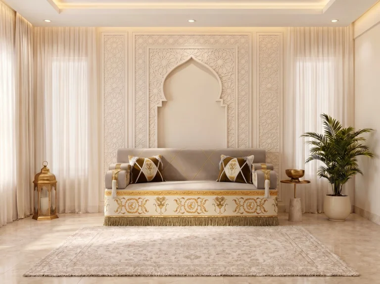 Single beige majlis sofa module with a gold baroque-embroidered base and fringe, centred in front of a carved arch wall
