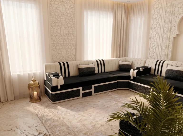 Corner of a black and cream striped majlis sofa set with fringed pillows, framed by a brass lantern and palm fronds