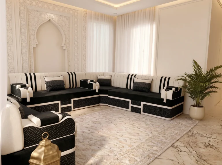Black and cream striped Arabic majlis in a U shape with key-pattern bases, viewed over a foreground armrest and lantern