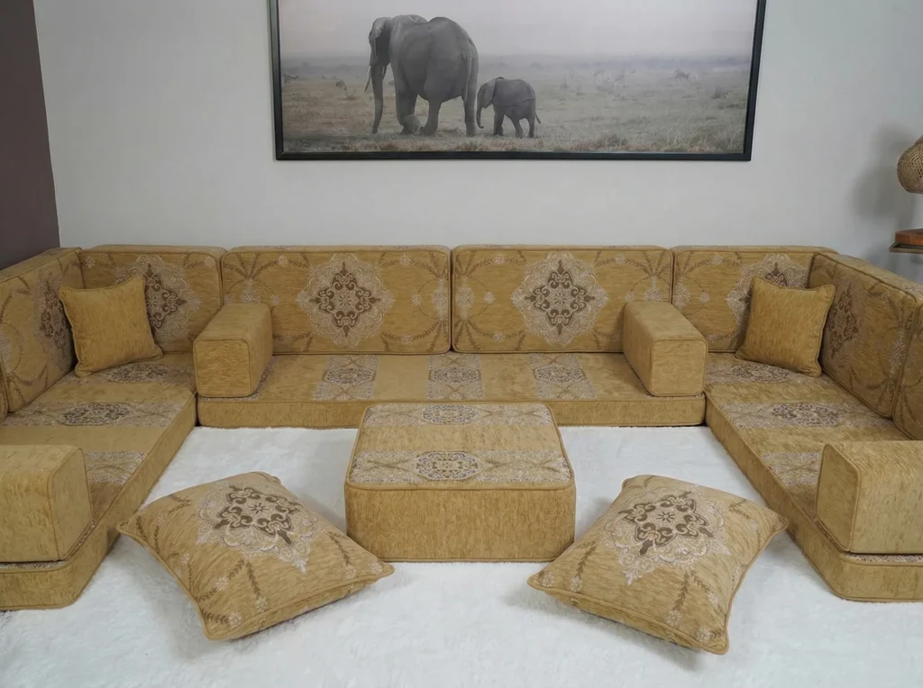 Mustard yellow floor seating set in a U shape with brown medallion back cushions around an ottoman