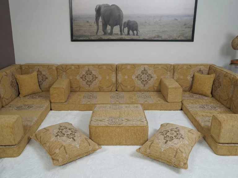 Mustard yellow floor seating set in a U shape with brown medallion back cushions around an ottoman