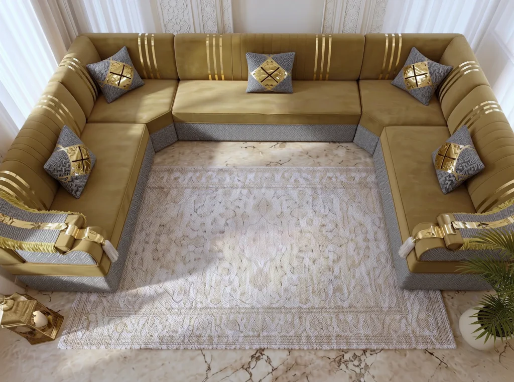 Overhead view of a U-shaped mustard velvet majlis sofa with five grey and gold cushions around a cream rug
