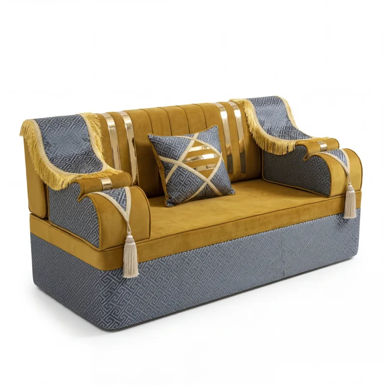 Mustard velvet majlis sofa piece on a slate blue key-pattern base with gold-fringed throws and cream tassels