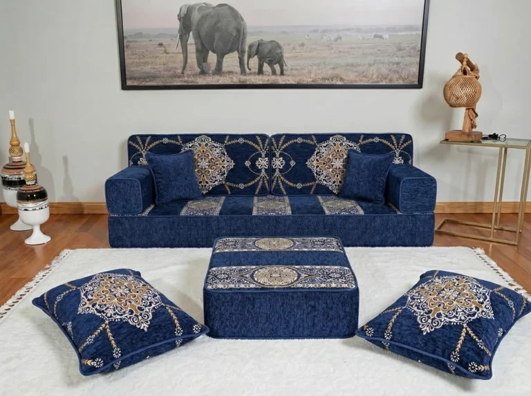 Low navy chenille floor sofa set with gold medallion cushions, ottoman and two floor cushions