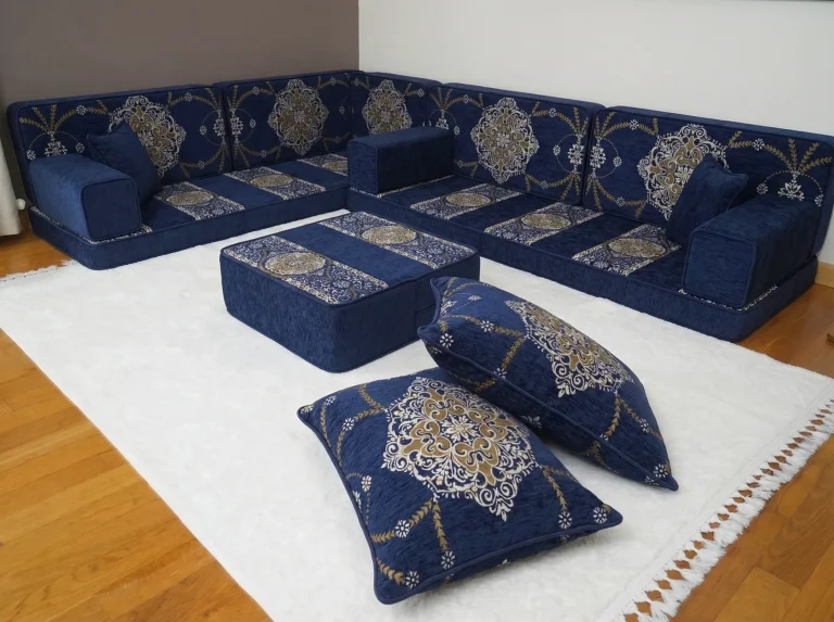 Navy and gold Arabic floor couch in an L shape with medallion cushions, ottoman and two stacked floor cushions