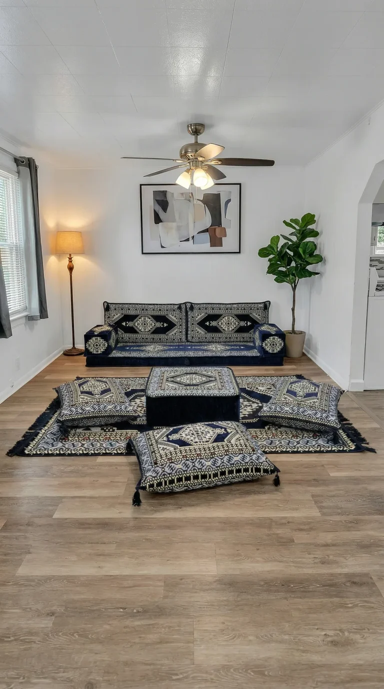 Navy and cream kilim-pattern Arabic sofa with ottoman, three floor cushions and matching rug in a white room