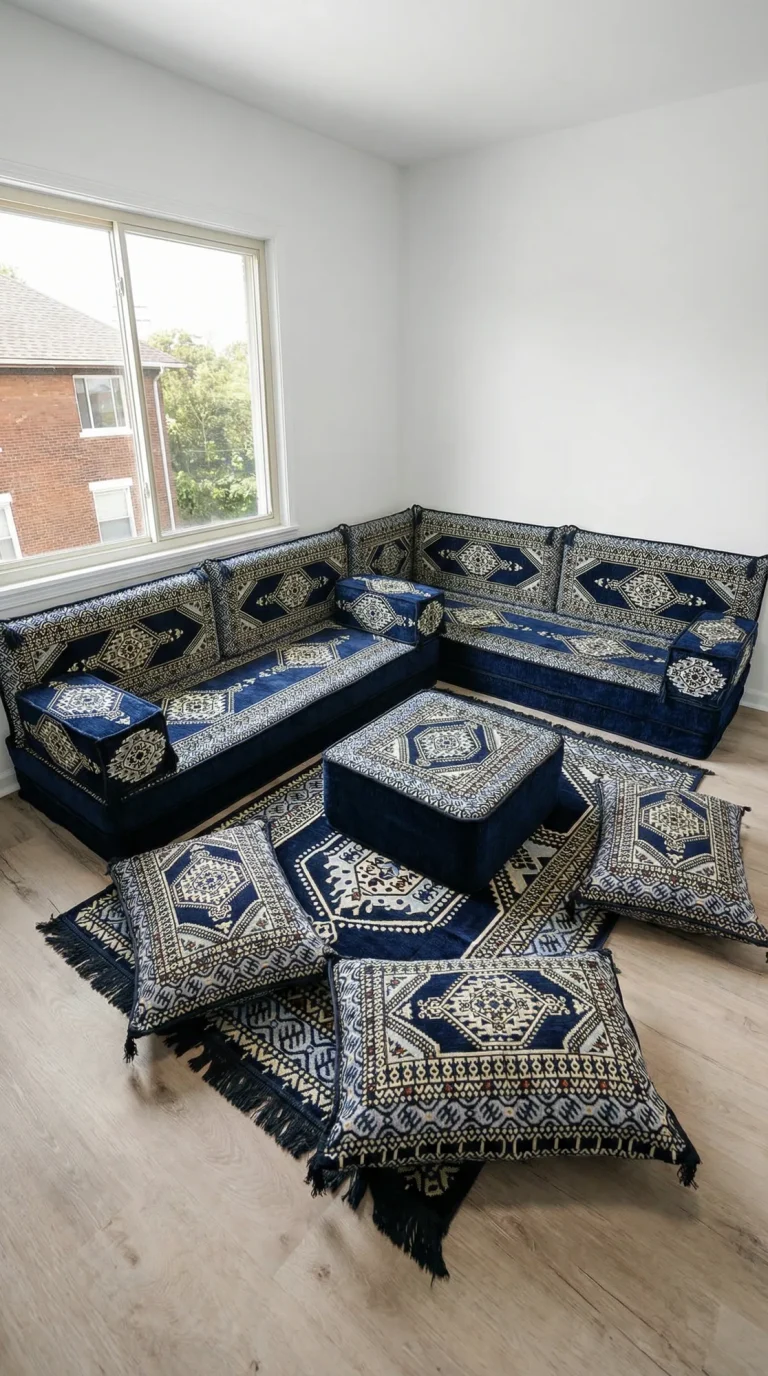 Navy and cream medallion Arabic floor sofa in an L shape under a window, seen from a high corner angle