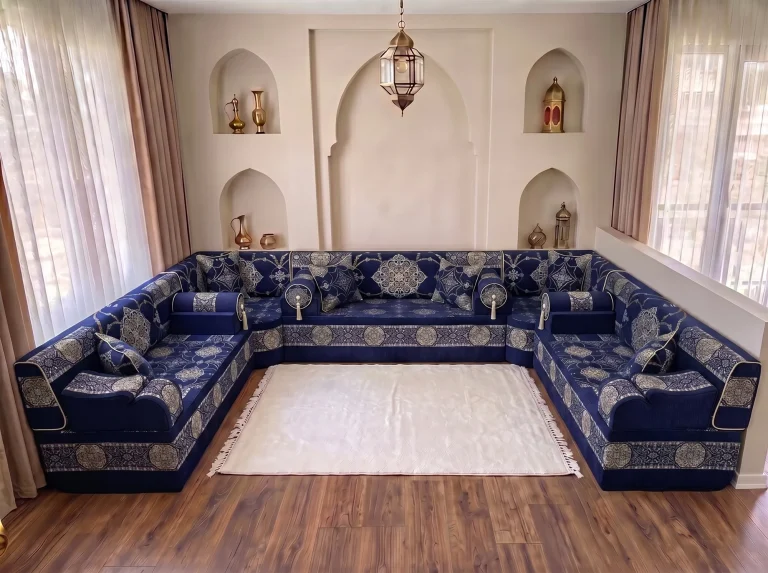 Navy Arabic jalsa with silver medallions arranged in a U shape around a plain white fringed rug