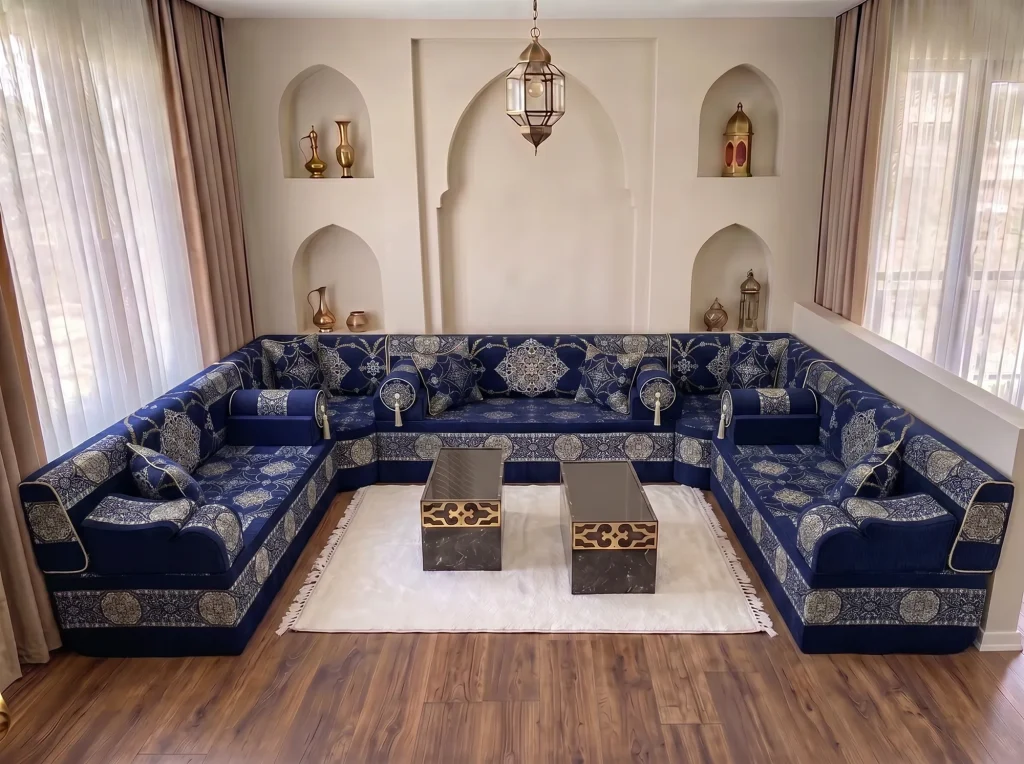 Navy Arabic majlis with silver medallions wrapping three walls in a U shape around a white rug and two coffee tables