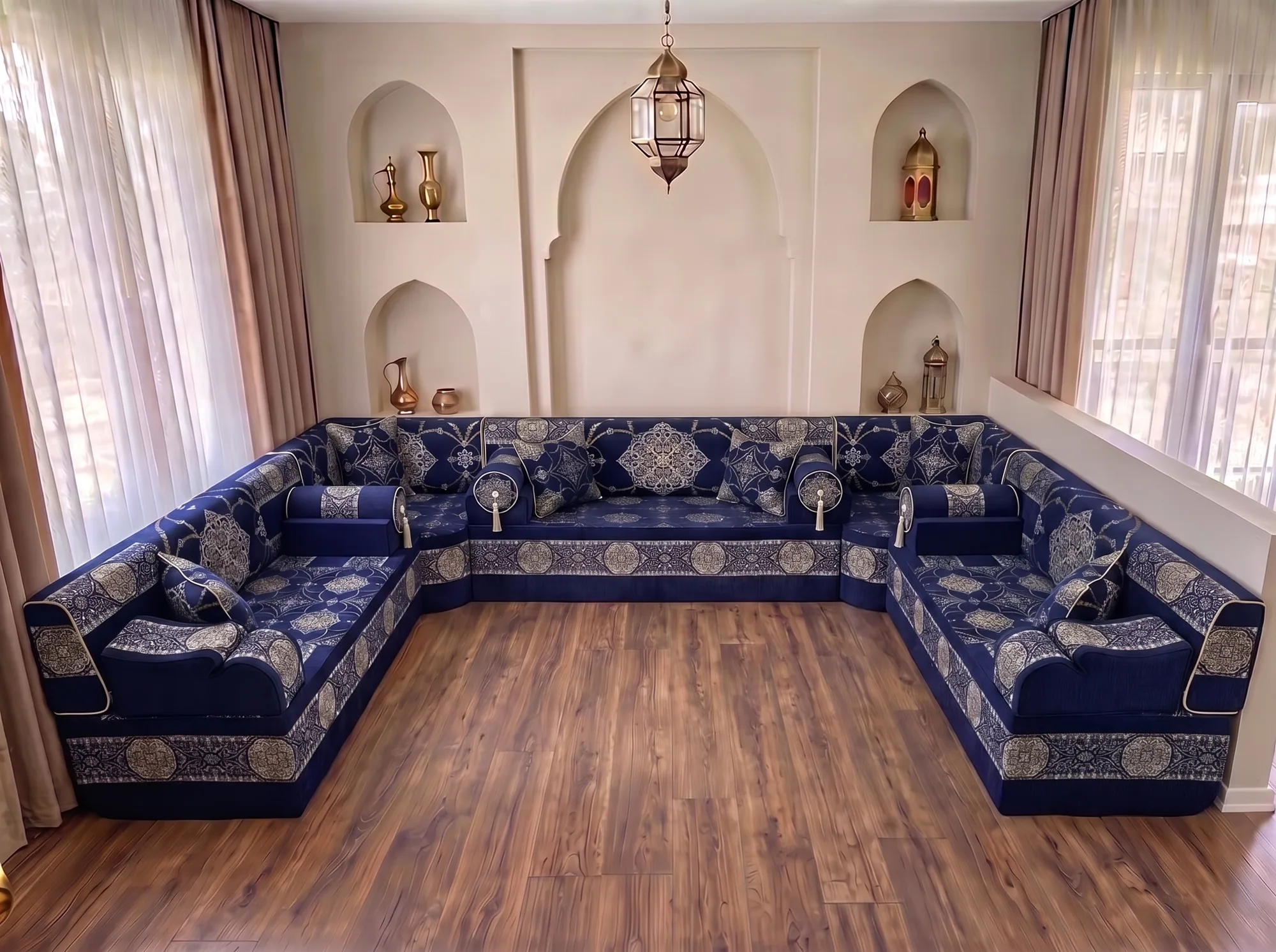 Navy majlis seating with silver medallion fabric in a U shape, shown without rug on a bare wooden floor