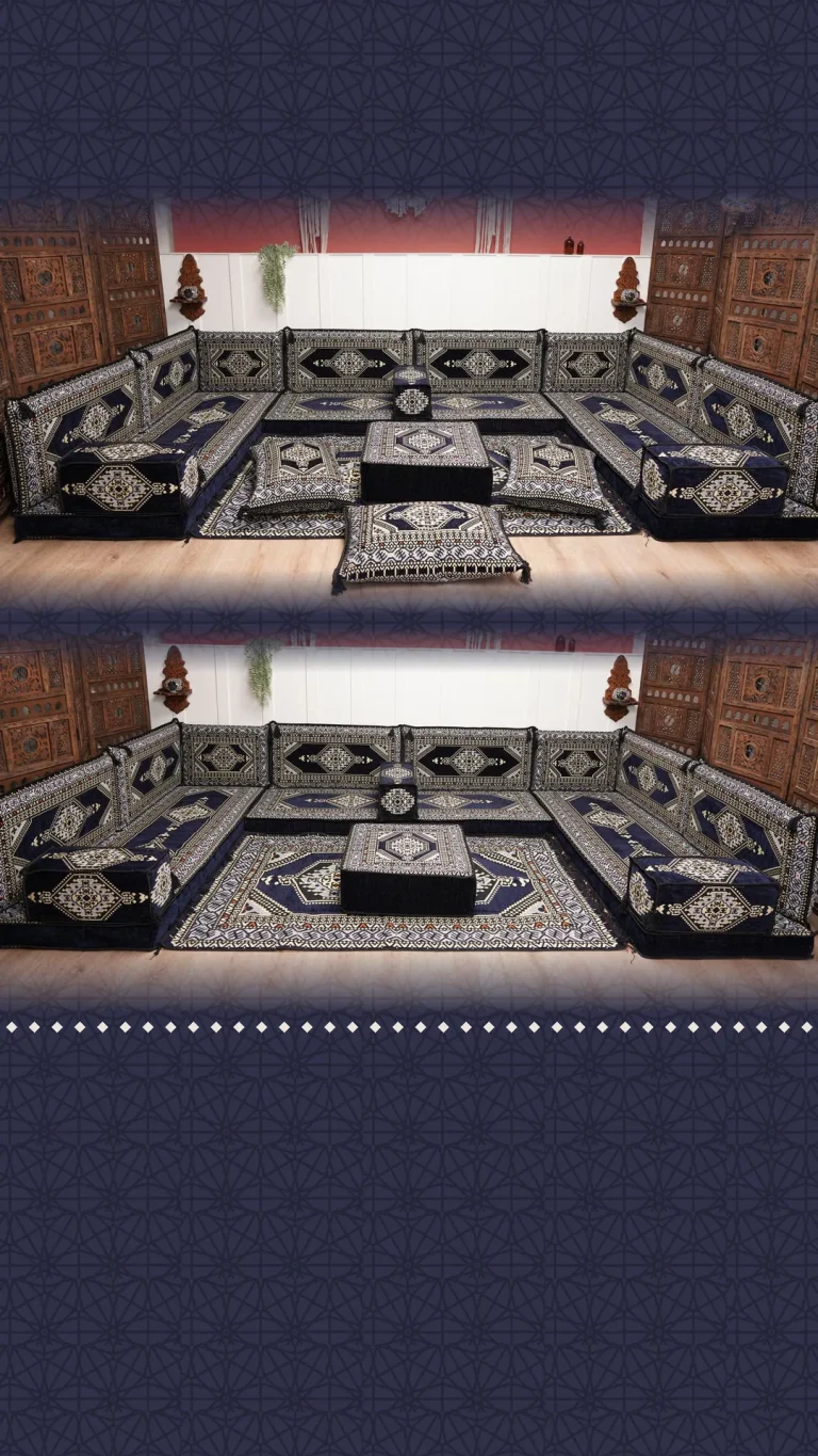 Navy and cream medallion floor sofa set in a wide U shape with pouf and rug between carved wooden door panels
