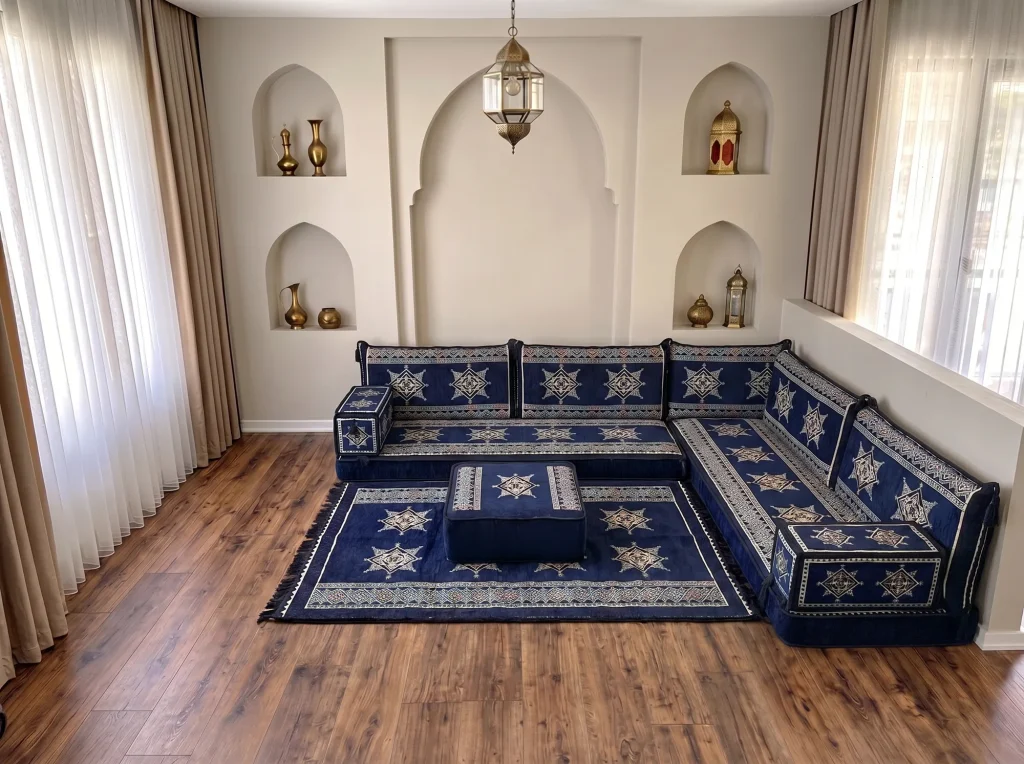 Navy star-pattern Arabic floor sofa in an L shape with a matching rug and a square ottoman placed in front