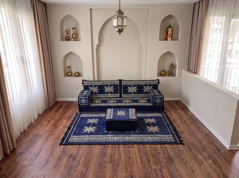 Navy Arabic floor couch with cream stars, a matching star rug and a square ottoman in an arched-niche room