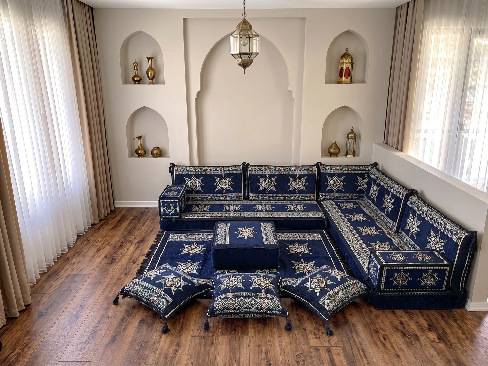Navy star-pattern floor sofa with cream star motifs in an L shape, with ottoman, star rug and floor cushions