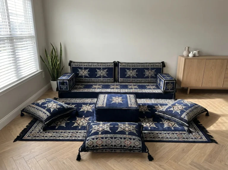 Navy floor sofa set with cream star motifs along a grey wall, with matching star rug, ottoman and three floor cushions