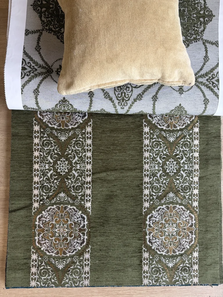 Olive green chenille upholstery fabric with two white ornamental bands and round medallions