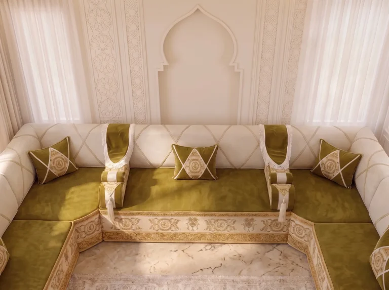 Olive velvet seats and ivory lattice backrests of a majlis sofa seen from above an arch
