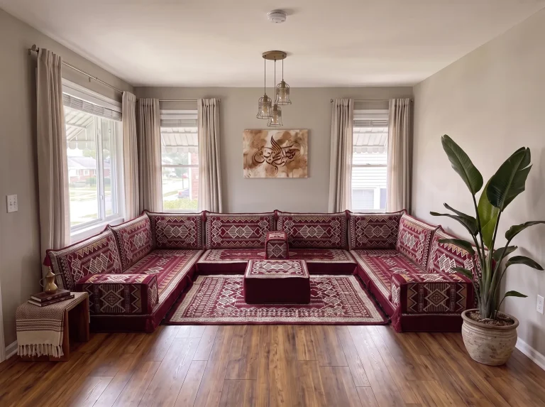 Burgundy and cream kilim U-shaped Arabic floor sofa with matching rug and ottoman in a grey living room
