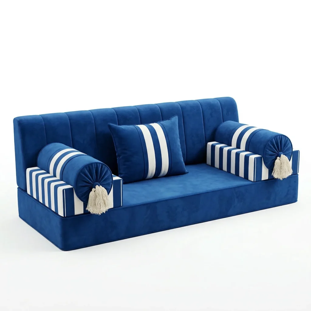 Royal blue velvet majlis sofa unit with white-striped armrests, round tasselled bolsters and a striped cushion, on white
