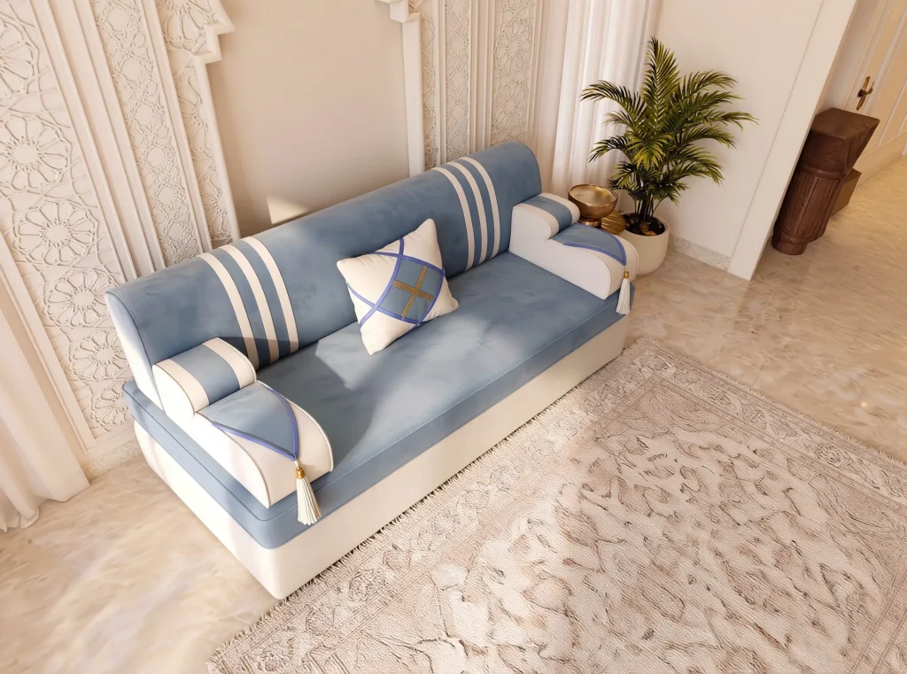 High-angle view of a single sky blue and cream majlis sofa seat with white stripes and a diamond cushion