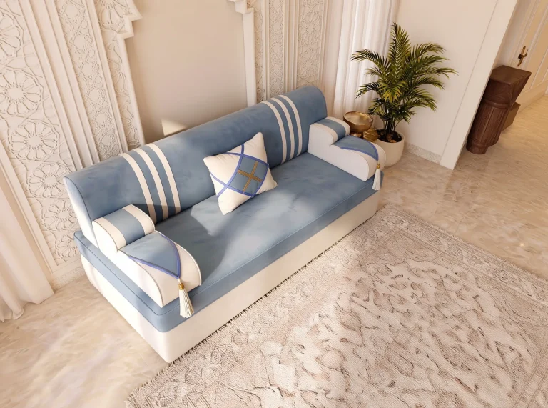 High-angle view of a single sky blue and cream majlis sofa seat with white stripes and a diamond cushion
