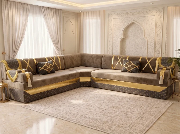 L-shaped taupe velvet Arabic majlis with gold crossed straps, gold fringe and a patterned charcoal base