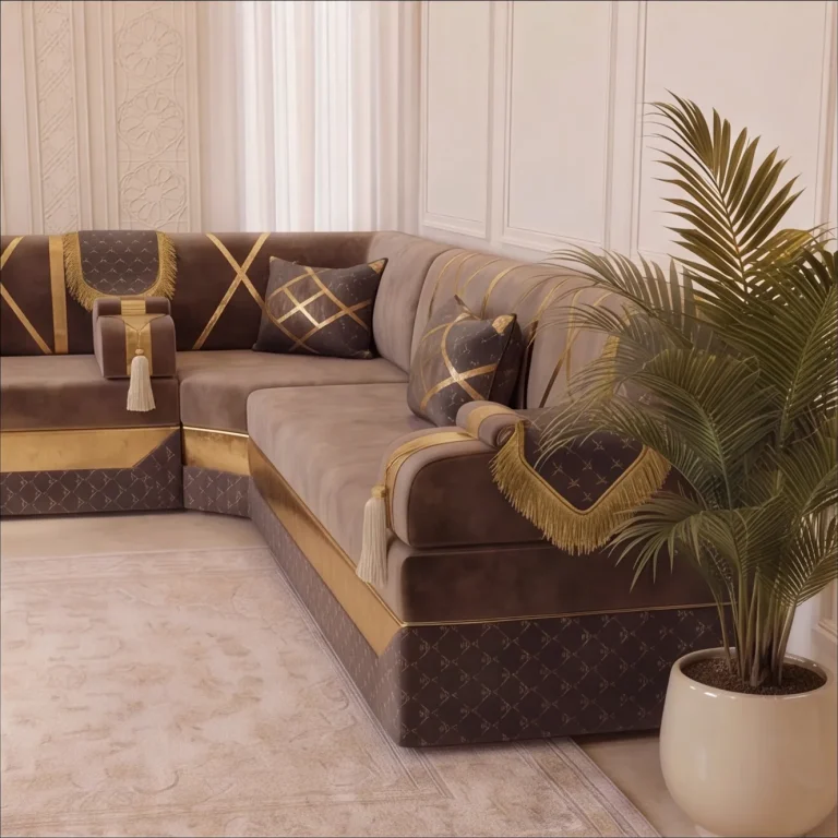 Corner of a taupe and gold Arabic jalsa with tasselled armrests, quilted charcoal base and a potted palm