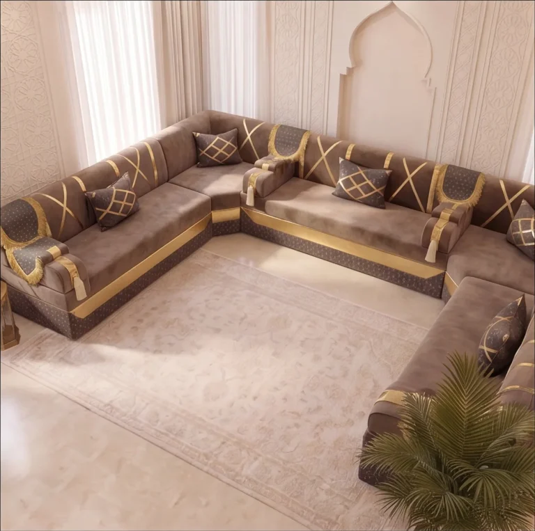 Elevated view of a taupe velvet U-shaped Arabic majlis with gold bands and a pale rug on a marble floor