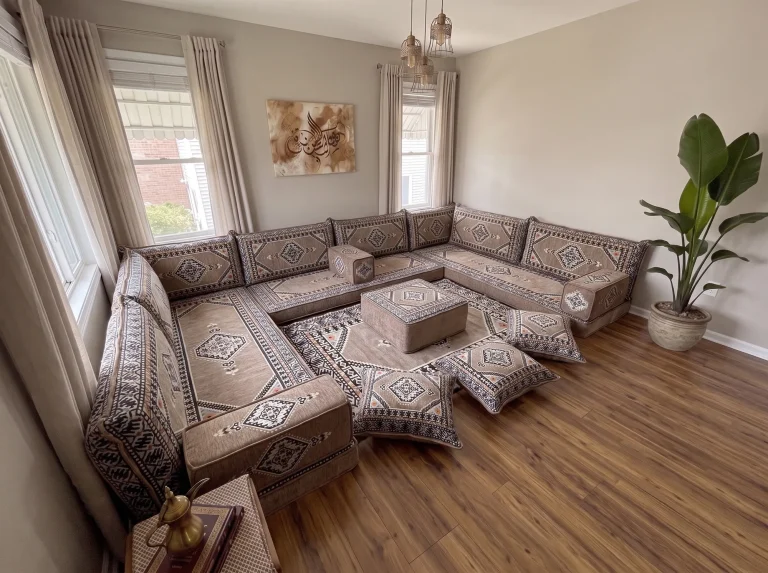 Taupe and black kilim U-shaped Arabic floor sofa with rug, ottoman and floor cushions, high corner view