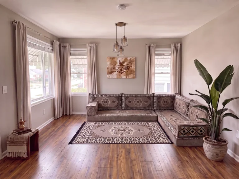 Taupe floor seating set with cream medallions in an L shape and a matching medallion rug in a gray living room