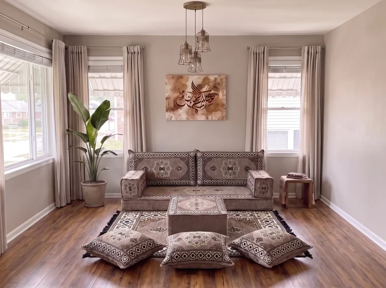 Taupe medallion single-row Arabic floor couch with rug, ottoman and floor cushions in a neutral living room, close view