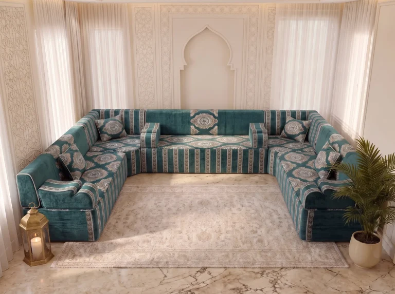 Teal velvet Arabic majlis in a U shape with medallion cushions and striped bases around a cream rug