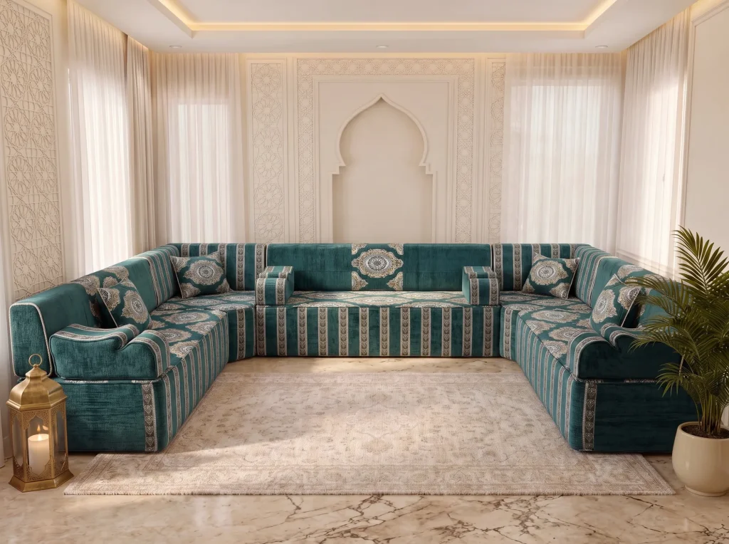 Teal velvet U-shaped Arabic majlis with ivory medallion cushions and striped base around a cream rug