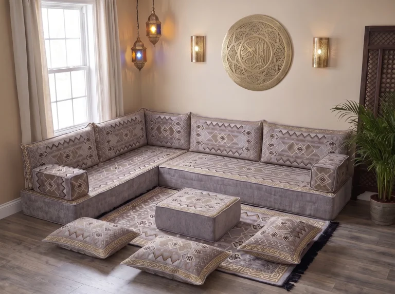 Thick gray and gold kilim Arabic floor sofa in an L shape with rug, ottoman and floor cushions below a brass wall plate