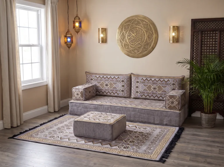 Thick gray and gold kilim-pattern floor seating set as a single row with matching rug and ottoman below a brass wall plate