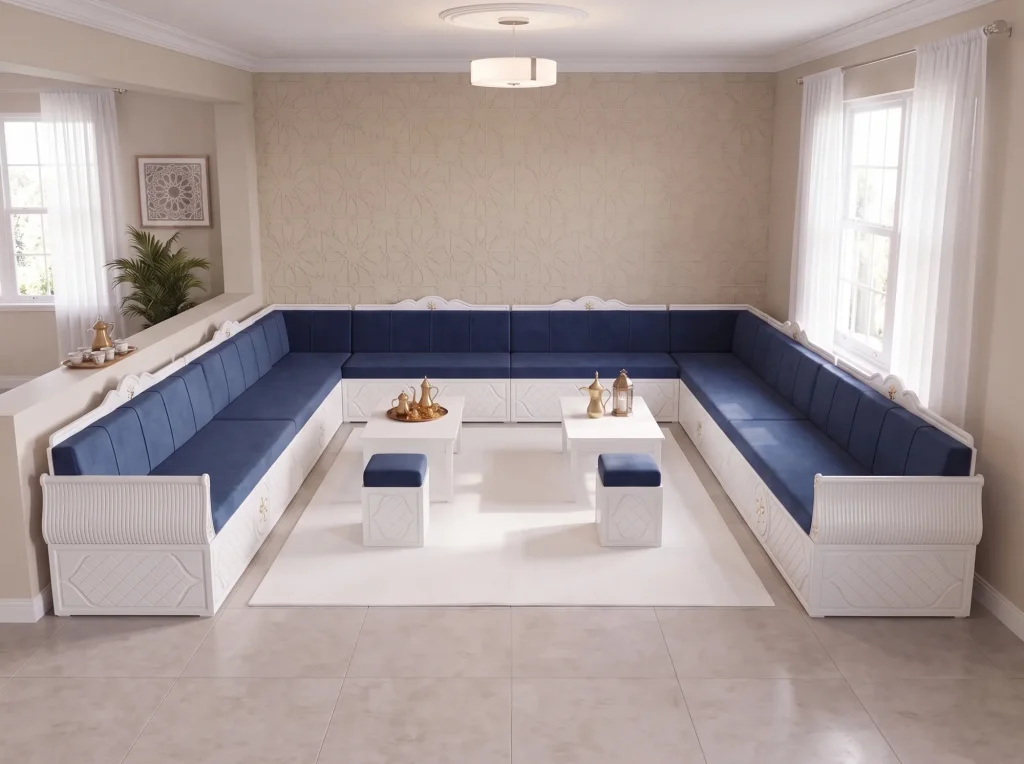 Elevated view of a white wooden majlis sofa set with navy velvet cushions, two tables and two ottomans
