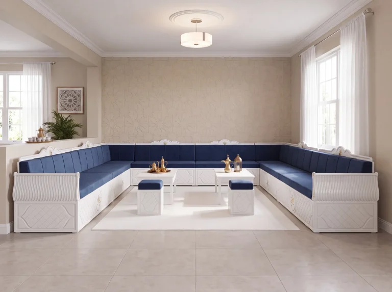 White wooden Arabic majlis in a U shape with navy velvet cushions, two coffee tables and brass coffee pots